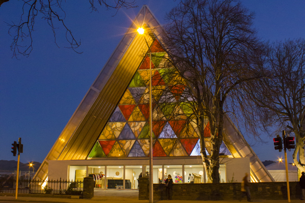 stain glass transitional_cardboard_cathedral_exterior_at_night_from_latimer_square