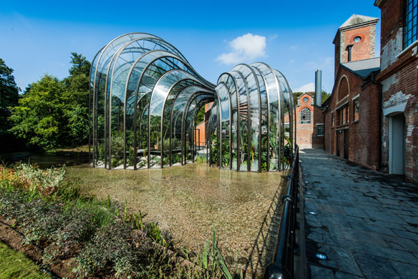 The-clear-water-of-the-River-Test-runs-past-the-spectacular-glasshouses-which-house-the-botanicals-at-Laverstoke-Mill